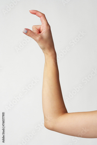 Hand picking something against white background copy space