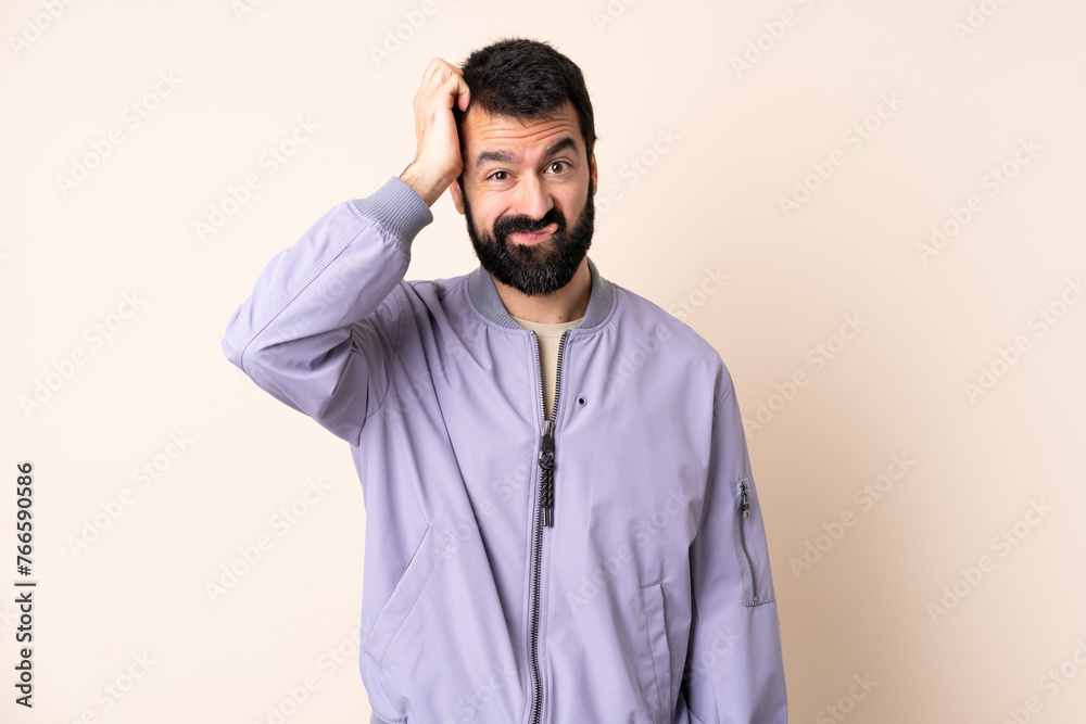 Caucasian man with beard wearing a jacket over isolated background with an expression of frustration and not understanding Caucasian man with beard wearing a jacket over isolated background with an expression of frustration and not understanding
