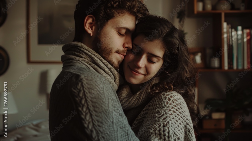 A man and a woman embracing in a cozy living room. Perfect for illustrating love and relationships A man and a woman embracing in a cozy living room. Perfect for illustrating love and relationships