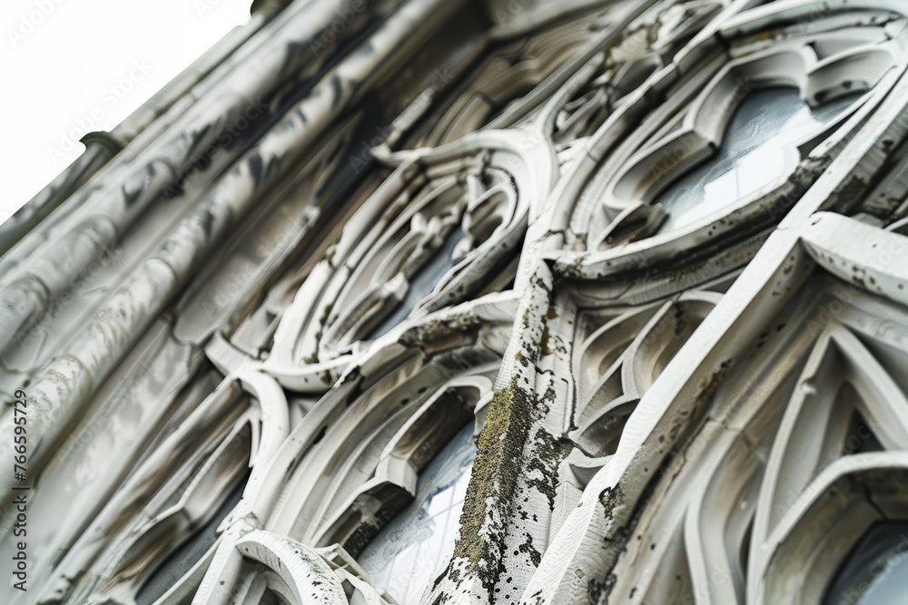 A detailed view of a Gothic window, its intricate tracery and weathered stone standing out against a pure white background. A detailed view of a Gothic window, its intricate tracery and weathered stone standing out against a pure white background.