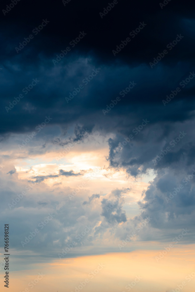 Dramatic sky with orange-blue clouds. Atmospheric scene before storm