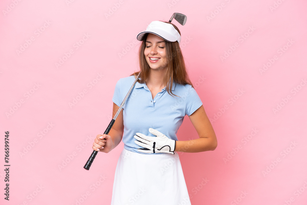 Young golfer player man isolated on pink background smiling a lot Young golfer player man isolated on pink background smiling a lot