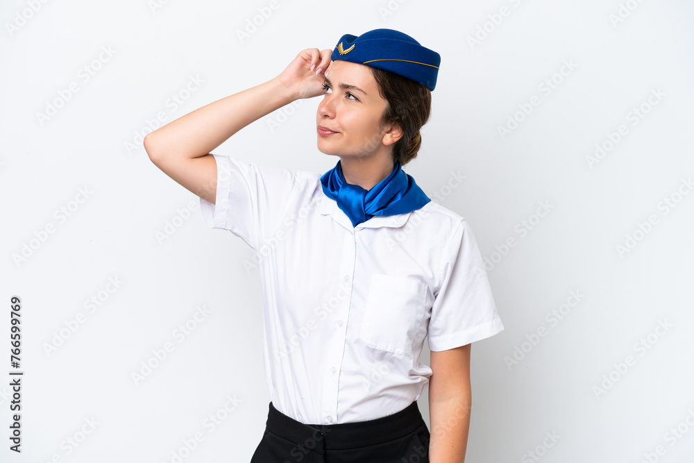 Airplane stewardess caucasian woman isolated on white background having doubts and with confuse face expression Airplane stewardess caucasian woman isolated on white background having doubts and with confuse face expression