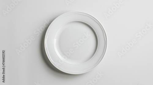 White plate hanging on white wall, suitable for kitchen or dining room decor
