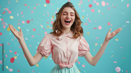 A jubilant woman with her arms raised in a sea of colorful confetti.