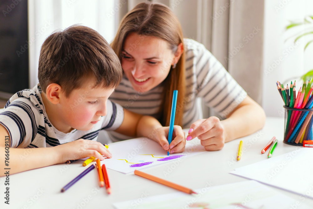 Mother and son drawing together with colorful pencils. Mother and son drawing together with colorful pencils.