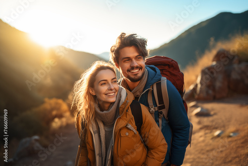 Young couple at outdoors with mountaineer backpack