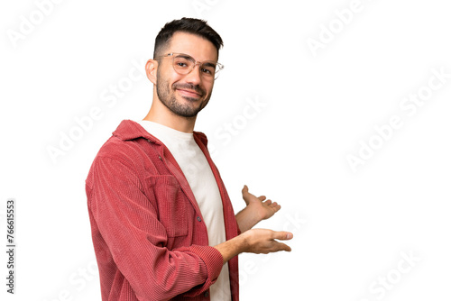 Konstfotografi Young handsome caucasian man over isolated chroma key background extending hands