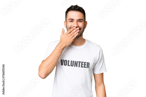 Young volunteer caucasian man over isolated chroma key background happy and smiling covering mouth with hand