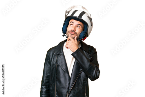 Young caucasian man with a motorcycle helmet over isolated chroma key background having doubts