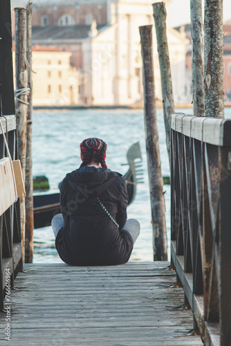 Female tourist watching tle lagoone view in Venice, Italy photo