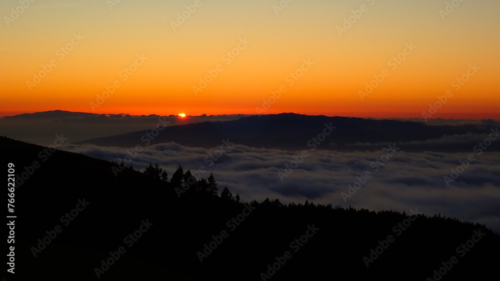 romantic view at sunset on a canary island in the clouds as seen from the Teide volcano