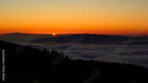 romantic view at sunset on a canary island in the clouds as seen from the Teide volcano