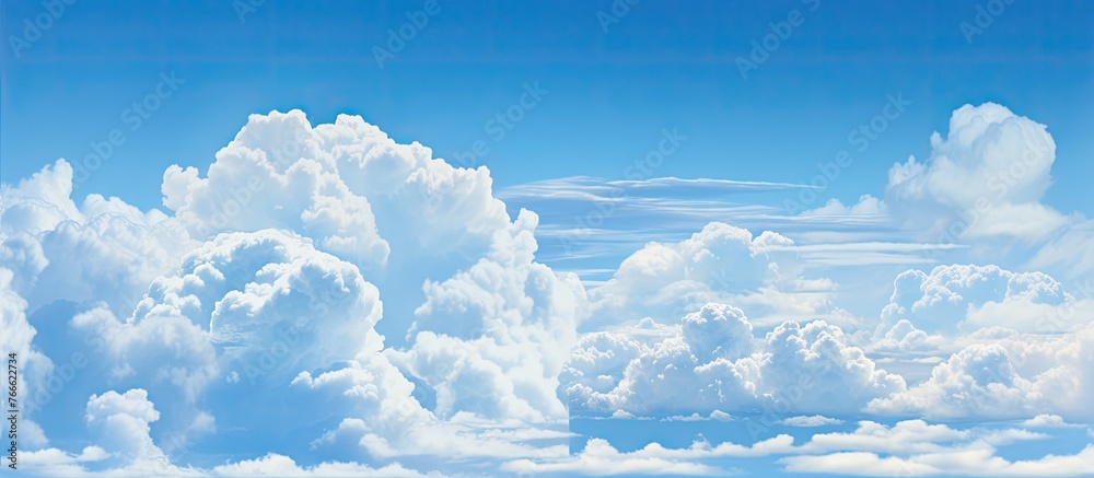 Clouds can be seen in the sky above a tranquil body of water like a lake or pond