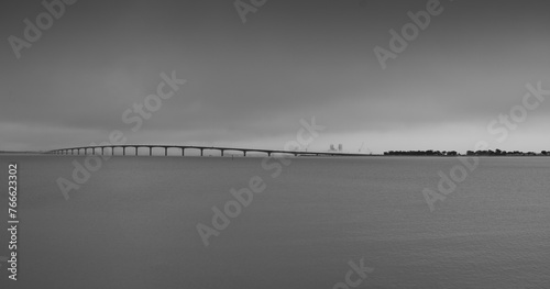 panoramic photo of the ile de re bridge in the fog. monochrome shot photo