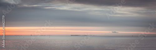 beautiful seascape with clouds over the sea  natural minimalistic background and texture  panoramic view banner. pastels tones