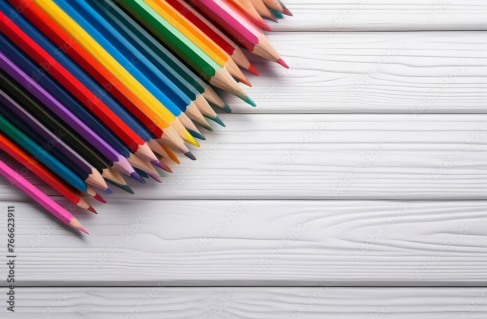 Colored pencils on white wood background with copy space, top view Colored pencils on white wood background with copy space, top view