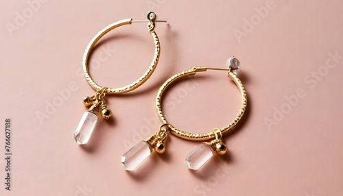 A Pair Of Hoop Earrings Adorned With Dangling Crys