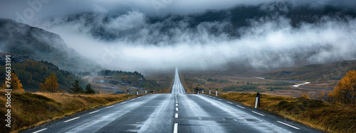 Isolation of straight highway road with clouds photo