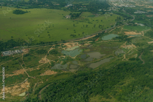 Beautiful nature in Brazilian lands with a lagoon  or river and its curves  seen from the top of an airplane  in aerial photographs