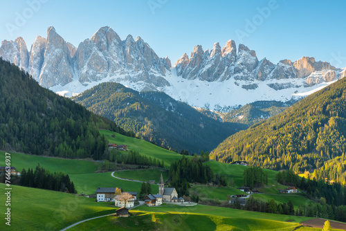 Morning landscape with Santa Magdalena village against the Geisler mountains covered with snow at sunrise  Val Di Funes valley in Dolomites mountains  South Tyrol  Italy. Italian Alps in springtime