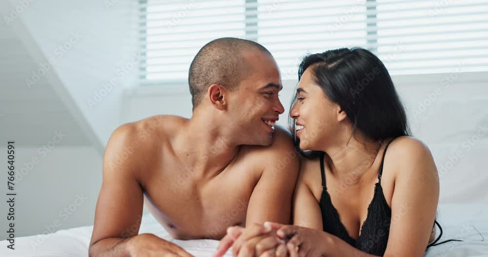 Happy couple, relax and kissing on bed for affection, morning romance or love in embrace, trust or care at home. Young man and woman smile lying in bedroom for intimacy, passion or bonding at house Happy couple, relax and kissing on bed for affection, morning romance or love in embrace, trust or care at home. Young man and woman smile lying in bedroom for intimacy, passion or bonding at house