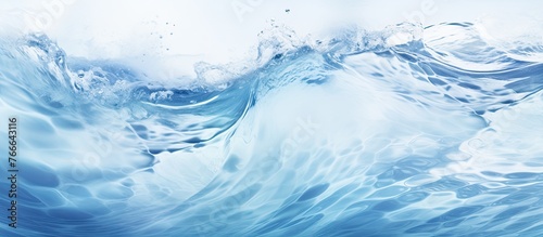 A detailed view of a wave breaking in the ocean with a vibrant blue sky in the background