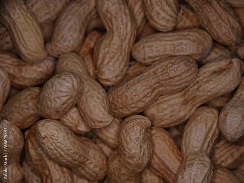 A pile of dried peanuts in shell close up. Healthy protein food