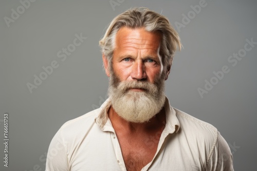 Handsome senior man with long white beard and mustache. Studio shot.
