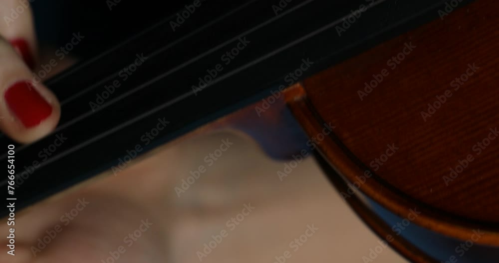Red nails and violin strings against blue background Red nails and violin strings against blue background