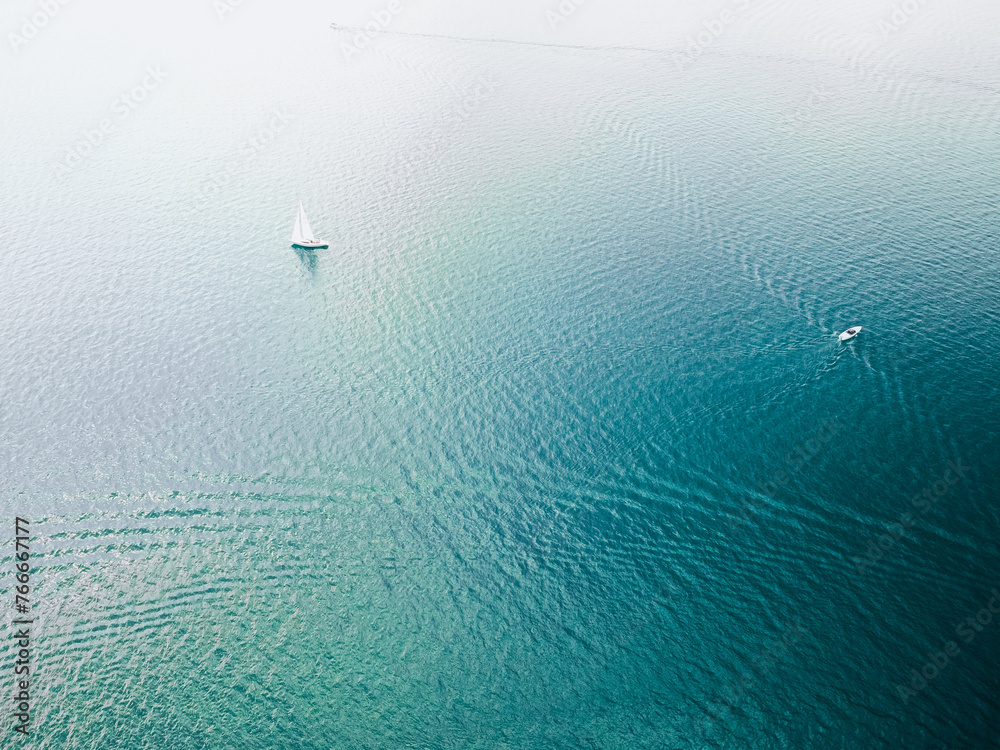 Aerial view of a white speed boat sailing in the blue sea.Drone view of a boat 
