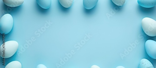 Blue-colored Easter egg frame arranged in a flat lay style with copy space for text visible from a top-down perspective.