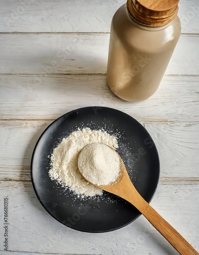 Black Plate with Protein Powder: Fitness Nutrition Preparation Scene with Wooden Spoon on Light White Wood Background, Next to a Wooden Lid Glass Jar, Highlighting an Active and Healthy Lifestyle