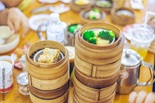 The background of food that is put in a wooden container (dim sum) containing vegetables, pork, flour Used to make, a menu that requires steaming stoves for good taste, delicious to eat © bangprik