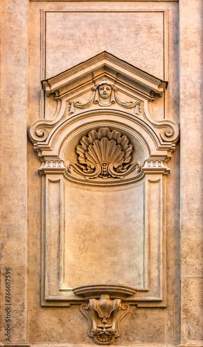 A beautiful wall frame outside a church in Rome, Italy