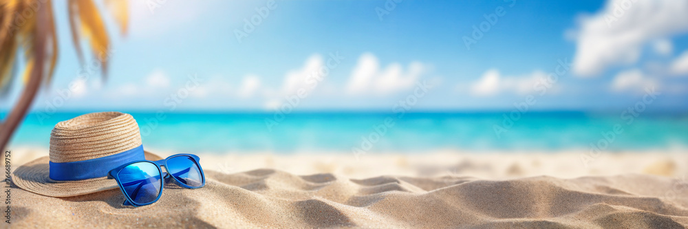Panoramic view of beautiful tropical beach with turquoise water. Straw hat with sunglasses on sandy beach with blue sea and sky background. Summer vacation concept.