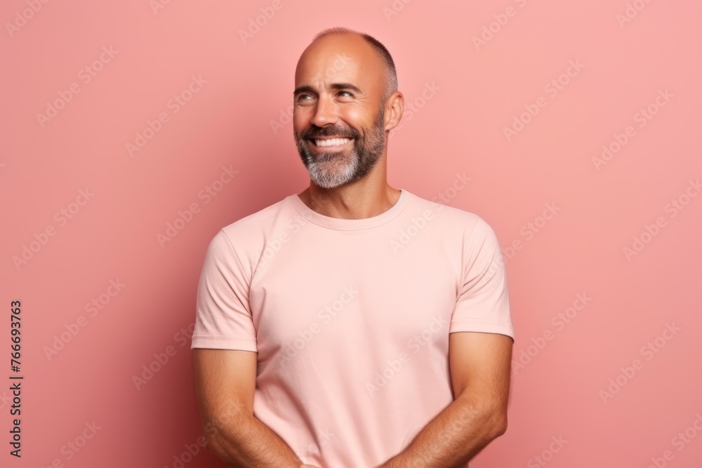 Portrait of handsome mature man in pink t-shirt on pink background Portrait of handsome mature man in pink t-shirt on pink background