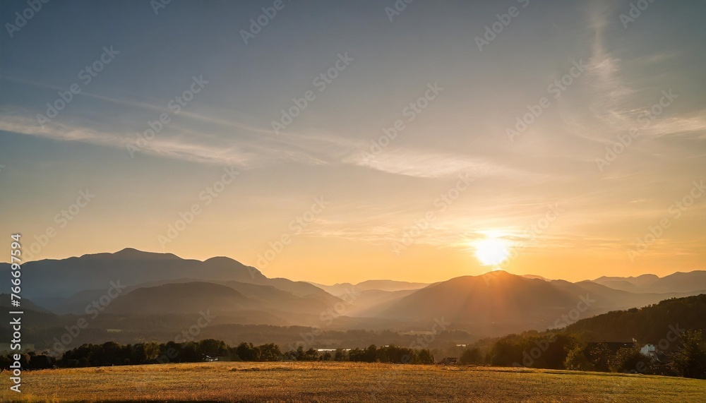 background of a breathtaking landscape the summer sky painted a beautiful canvas as the sun gently set behind the majestic autumn mountains creating a stunning sunset