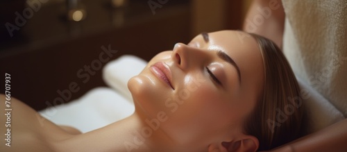 A woman is enjoying a relaxing head massage at the spa, feeling the tension melt away from her nose, cheeks, jaw, and ears as the therapists skilled thumbs work their magic