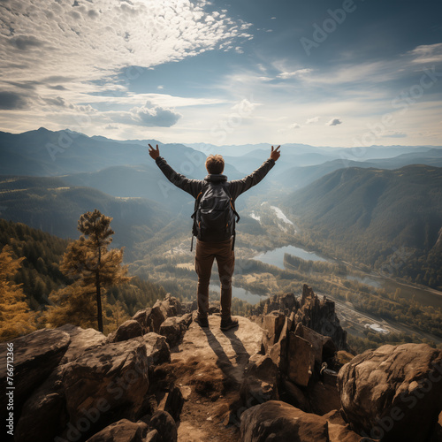 Happy man with arms up standing on the top of the mountain (Successful hiker celebrating success on the cliff ) Can be used in various fields: achievement, mountaineering, environment, etc.