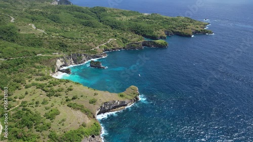 Forward reveal drone footage of Korawa Beach and Dolphin Bay on sunny day. Nusa Penida, Indonesia. photo