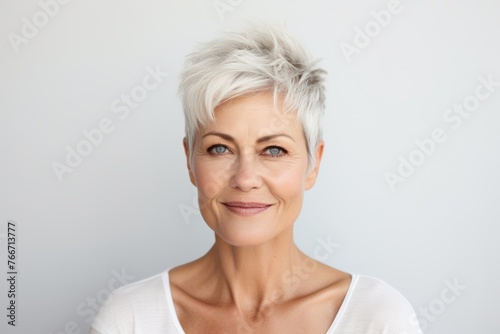 Closeup portrait of a beautiful middle aged woman with short white hair