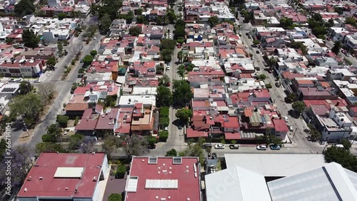 Urban landscape. Aerial shot. Travelling forward and tilt up over city houses.