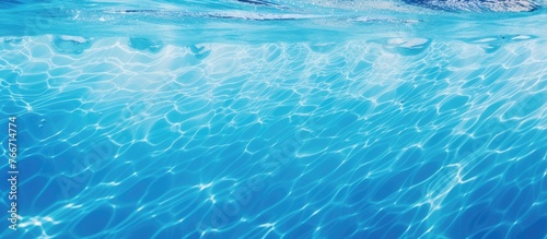 A detailed view of the surface of a body of water in a deep blue color with gentle waves photo