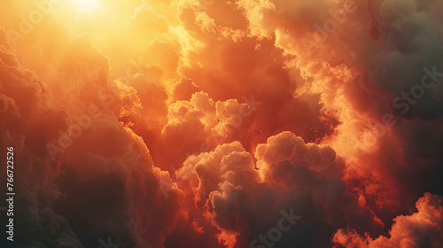 sunset with a sky filled with clouds. The clouds are fluffy and in various shades of orange and gray.