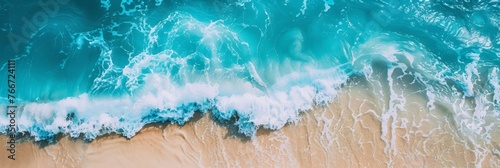 Crisp and clear aerial image of ocean waves crashing onto a sandy beach, illustrating the power of the sea