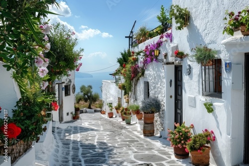 Whitewashed Greek alley flowerpots sea view