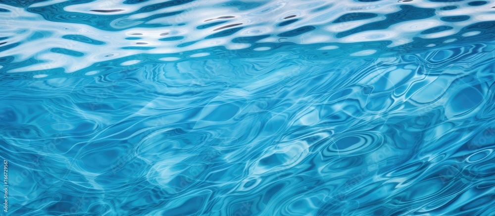 A detailed view of the surface of a body of water in a deep blue color, with small waves causing ripples A detailed view of the surface of a body of water in a deep blue color, with small waves causing ripples
