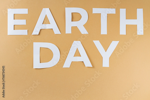 Fototapeta Naklejka Na Ścianę i Meble -  Earth Day Text on Beige Background, Concept of Environment World Earth Day, Copy Space