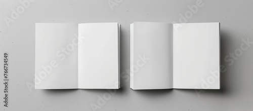 Design concept showing a white notebook from a top view, with blank pages opened, turned, and flipped on a gray background for a mockup. The image is a real photograph, not a . photo